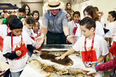 National Park Service members show Island School students different animals.